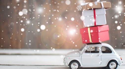 Gift boxes stacked on top of a retro car